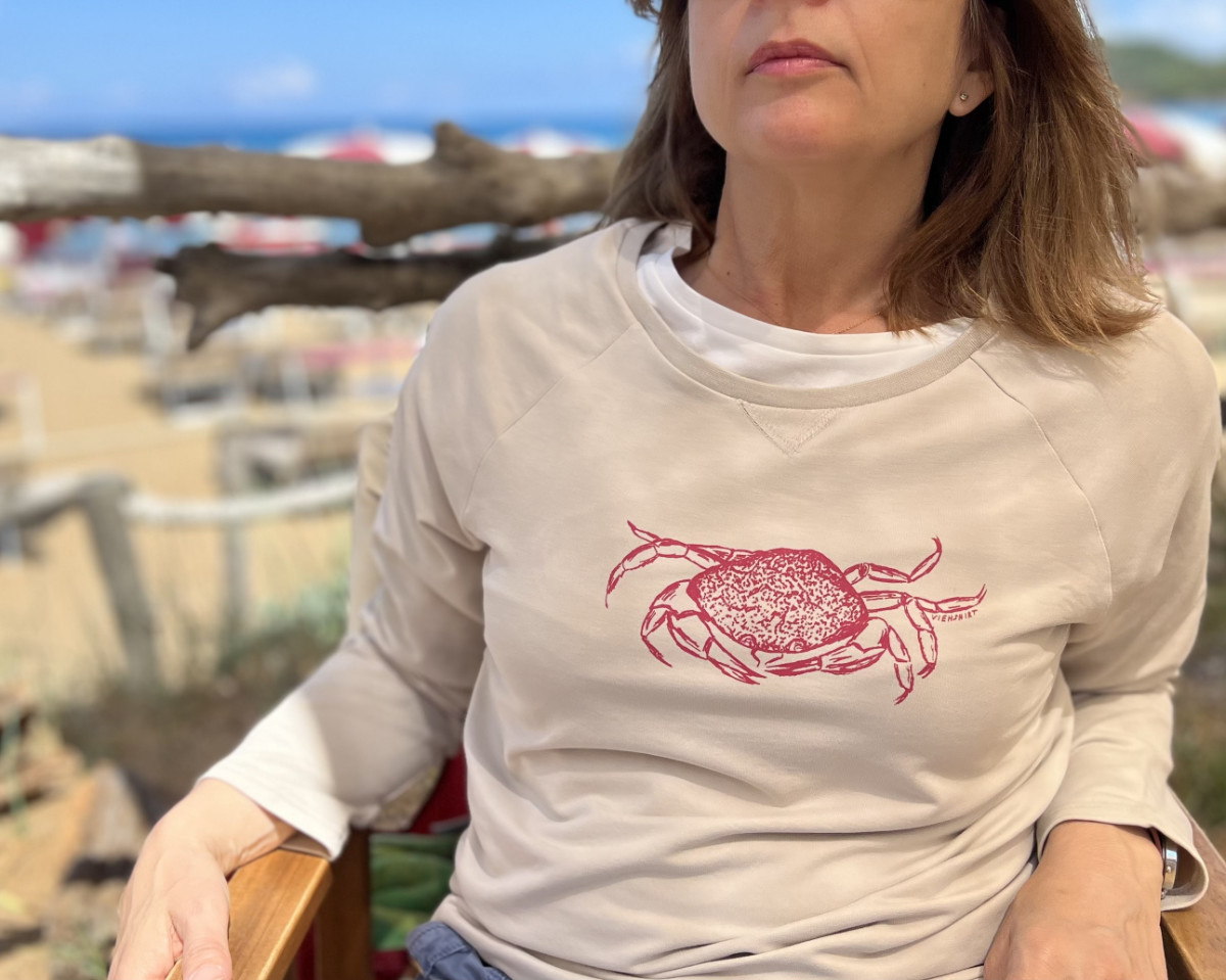 Frau trägt sandfarbenen Sweater mit Siebdruckmotiv Krabbe